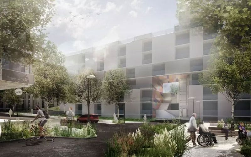 A courtyard in front of a three-storey building.