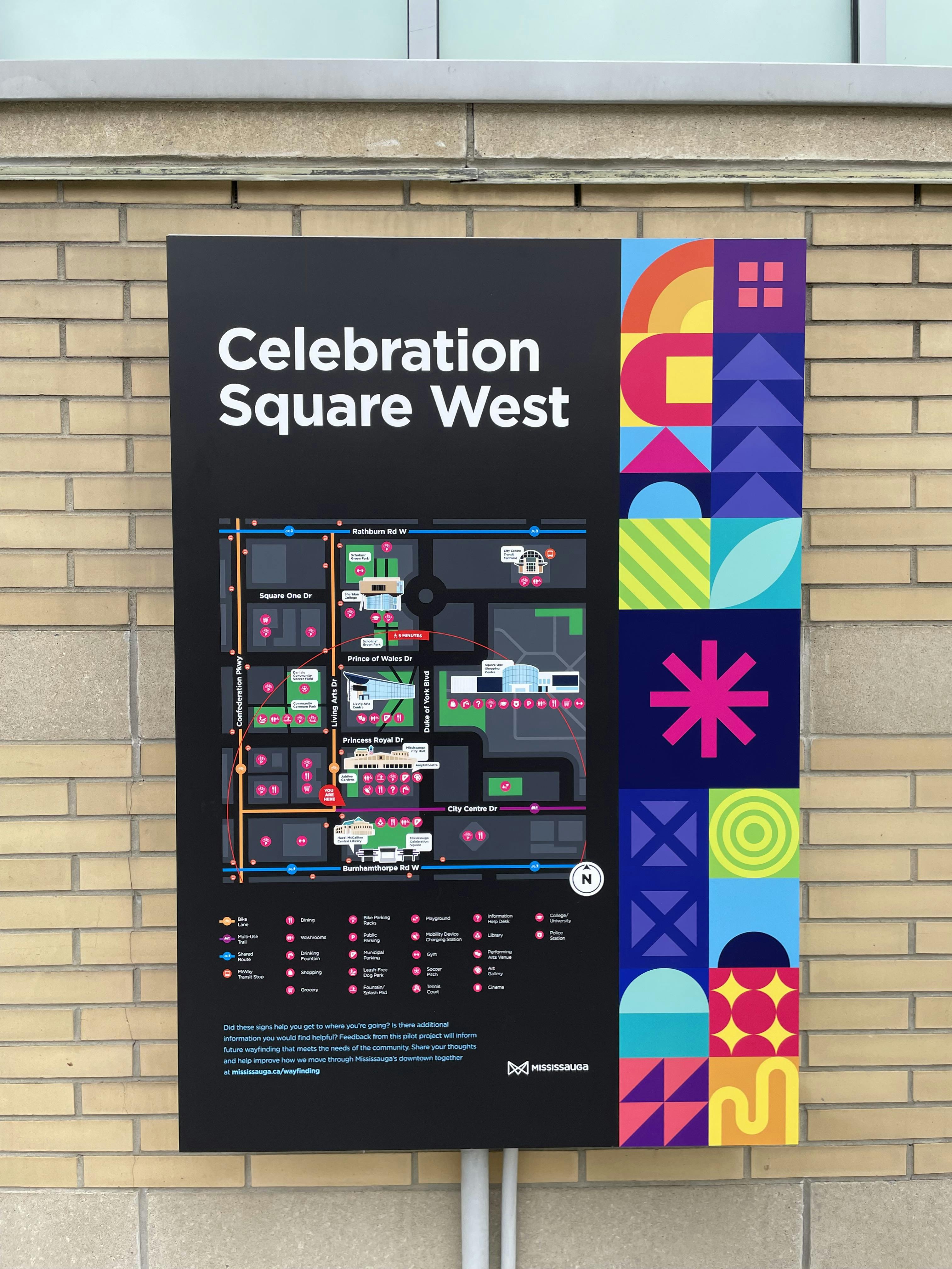 Colourful directional sign for Celebration Square West, featuring a detailed map and key for navigating the area.