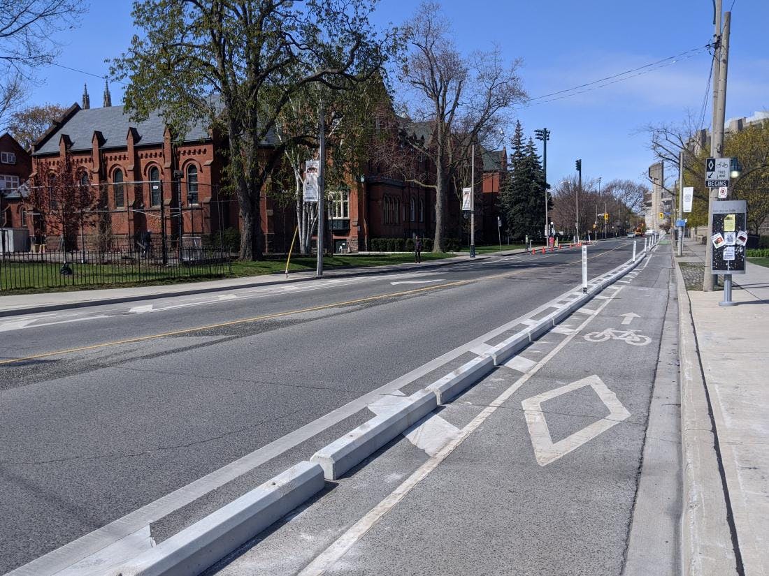 Protected Bike Lane Toronto Hoskin Ave (source: https://www.cycleto.ca/toronto-bikeways-bike-lanes-multi-use-paths-and-more#:~:text=Protected%20bike%20lanes%20are%20physically,to%20ride%20in%20the%20city.)