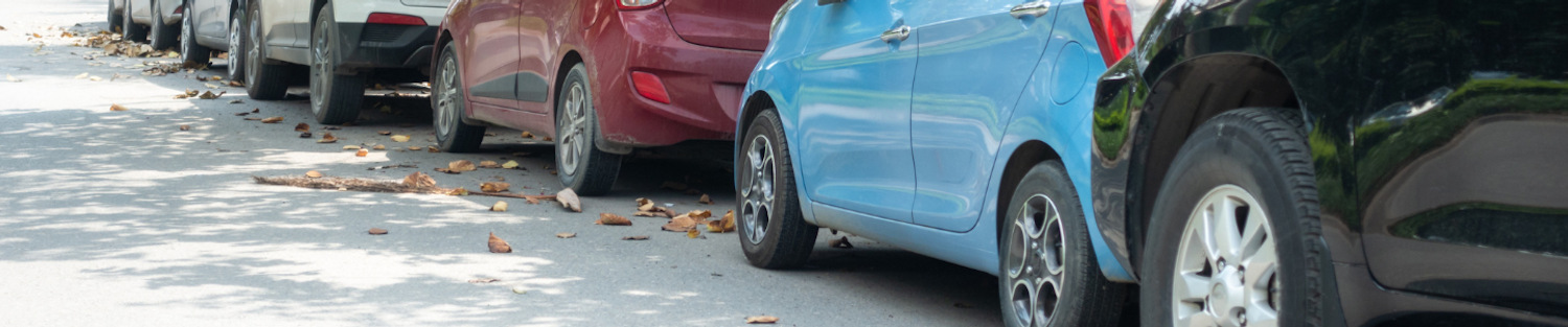 a row of cars parked on the side of the road