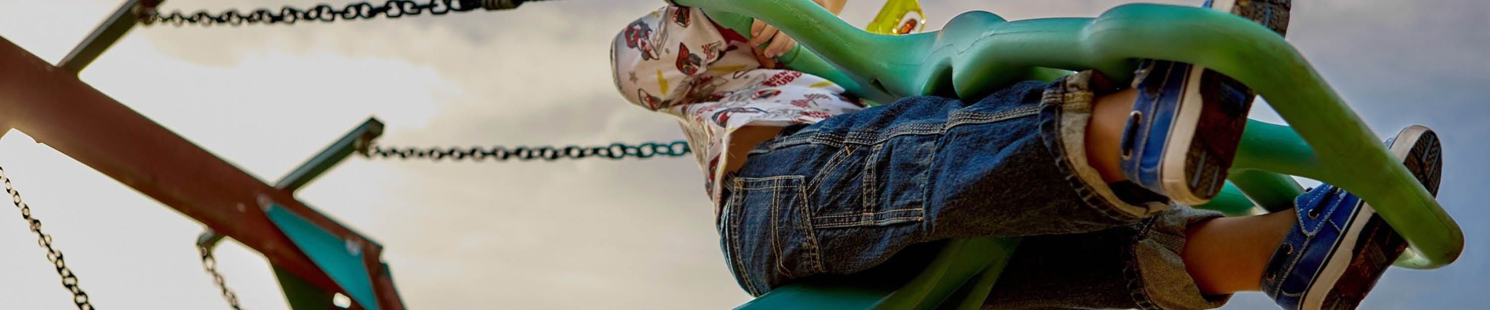 Child on green swing