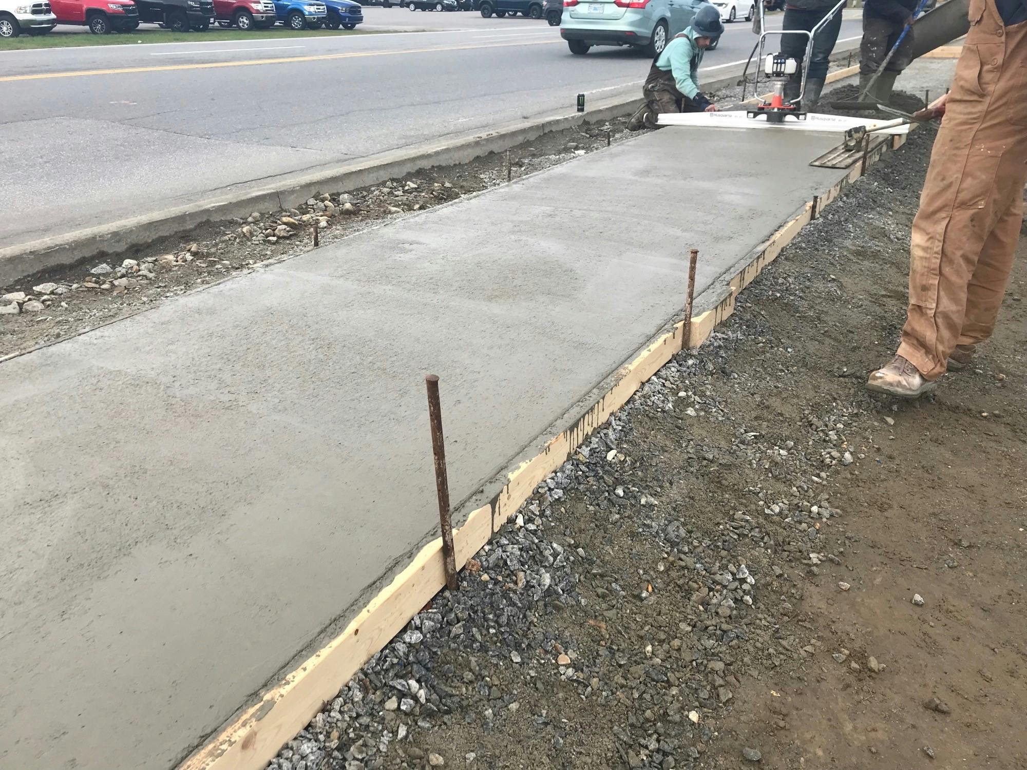 Sidewalk being poured along Starrs Road in front of Home Hardware.