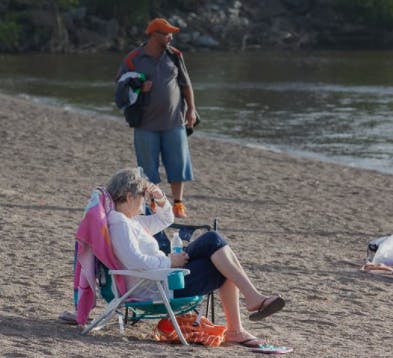 A couple relaxes on Dominion Park beach