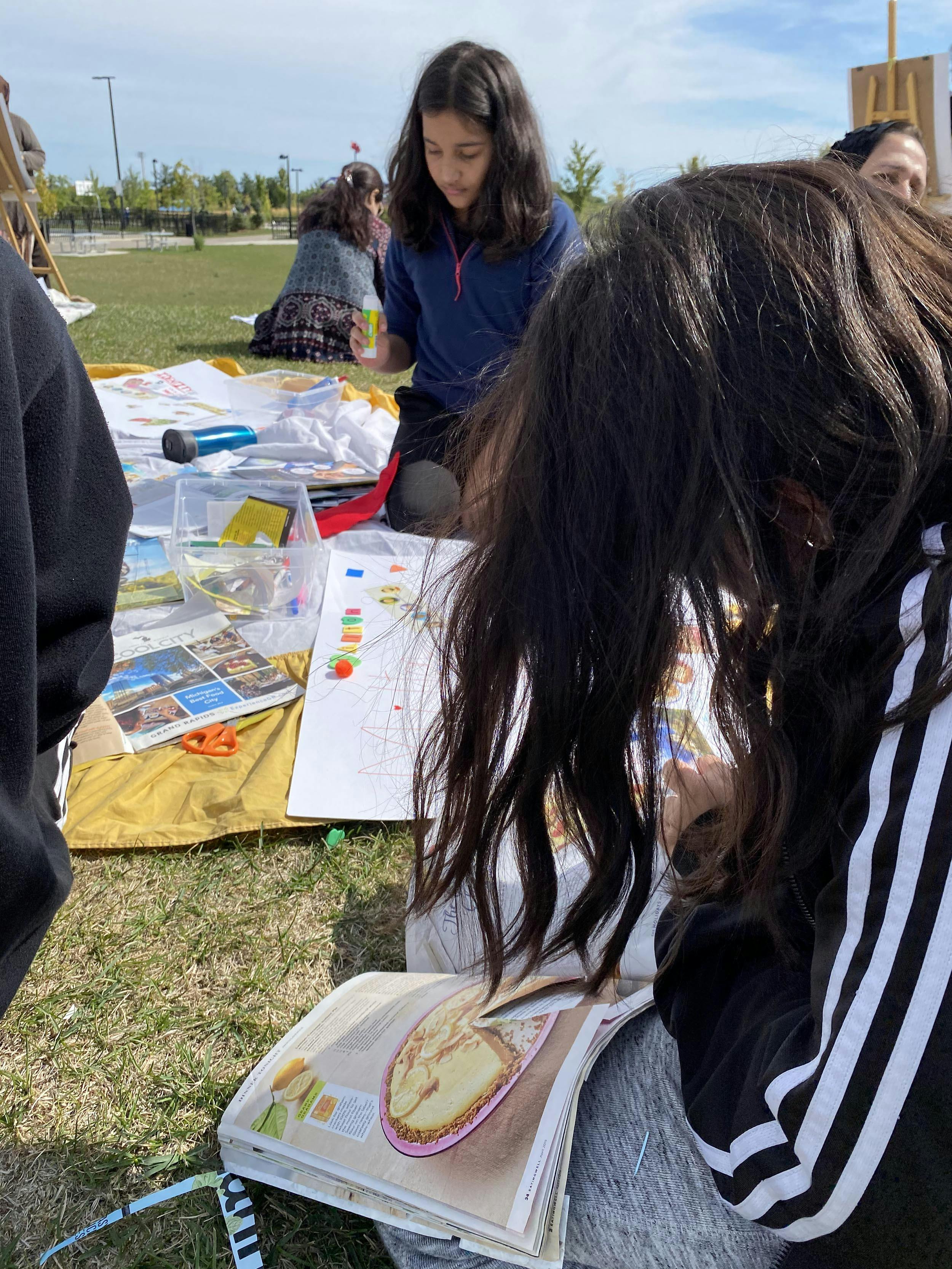 Young person looking through magazines. 