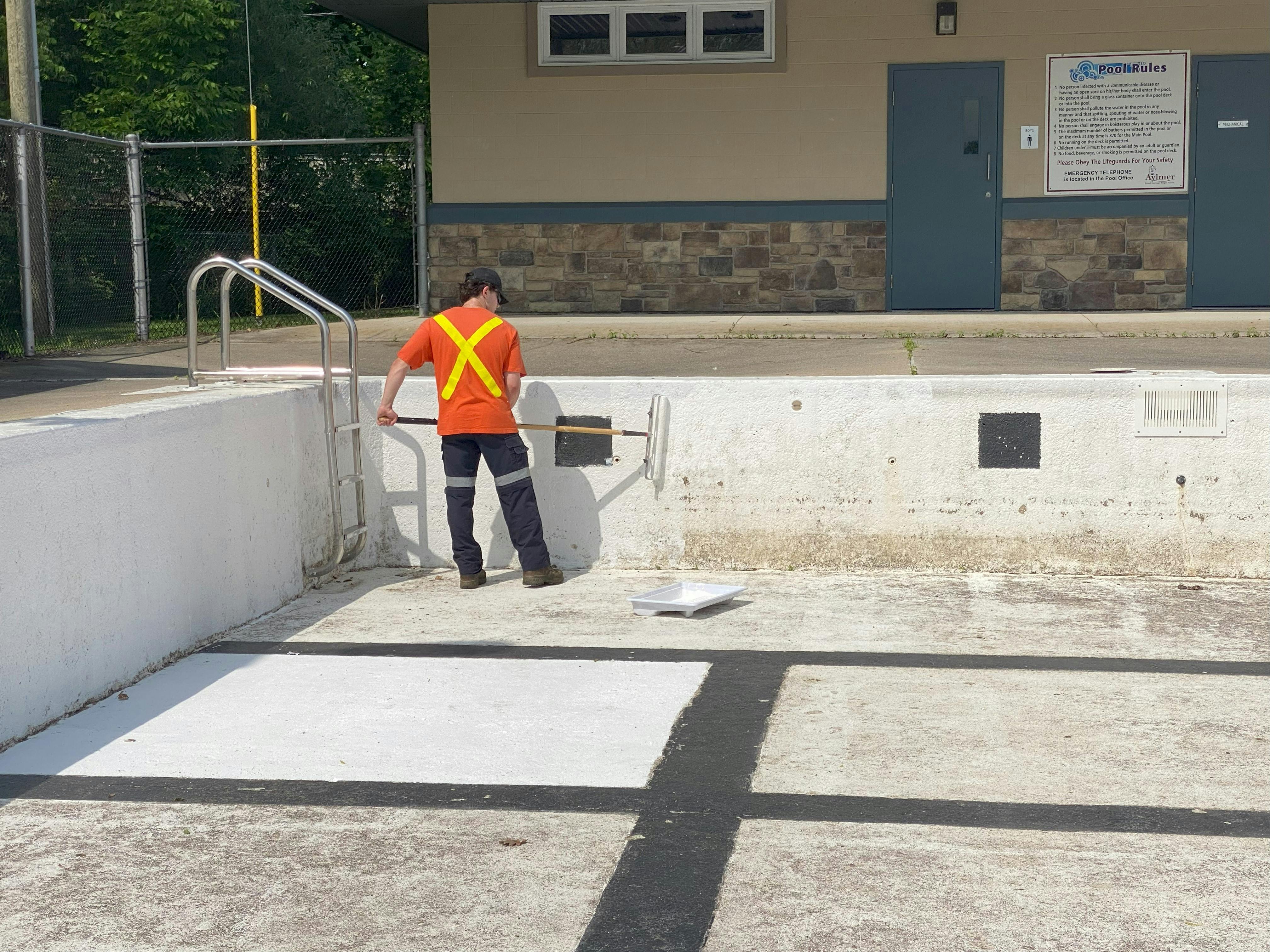 Worker painting the pool