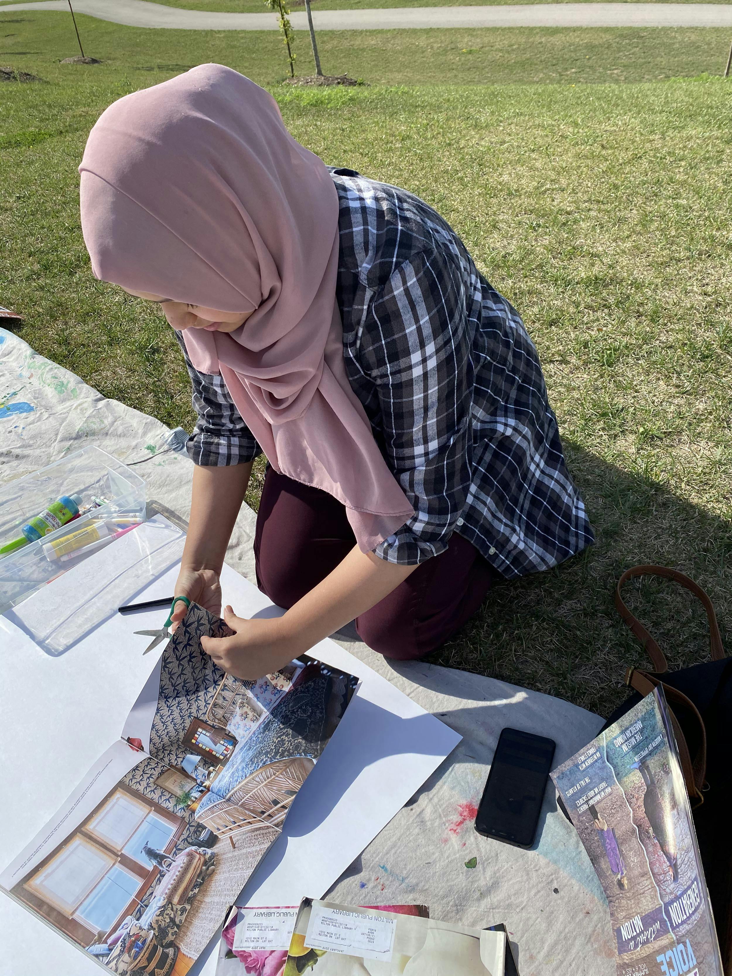 Saleha working on a collage.
