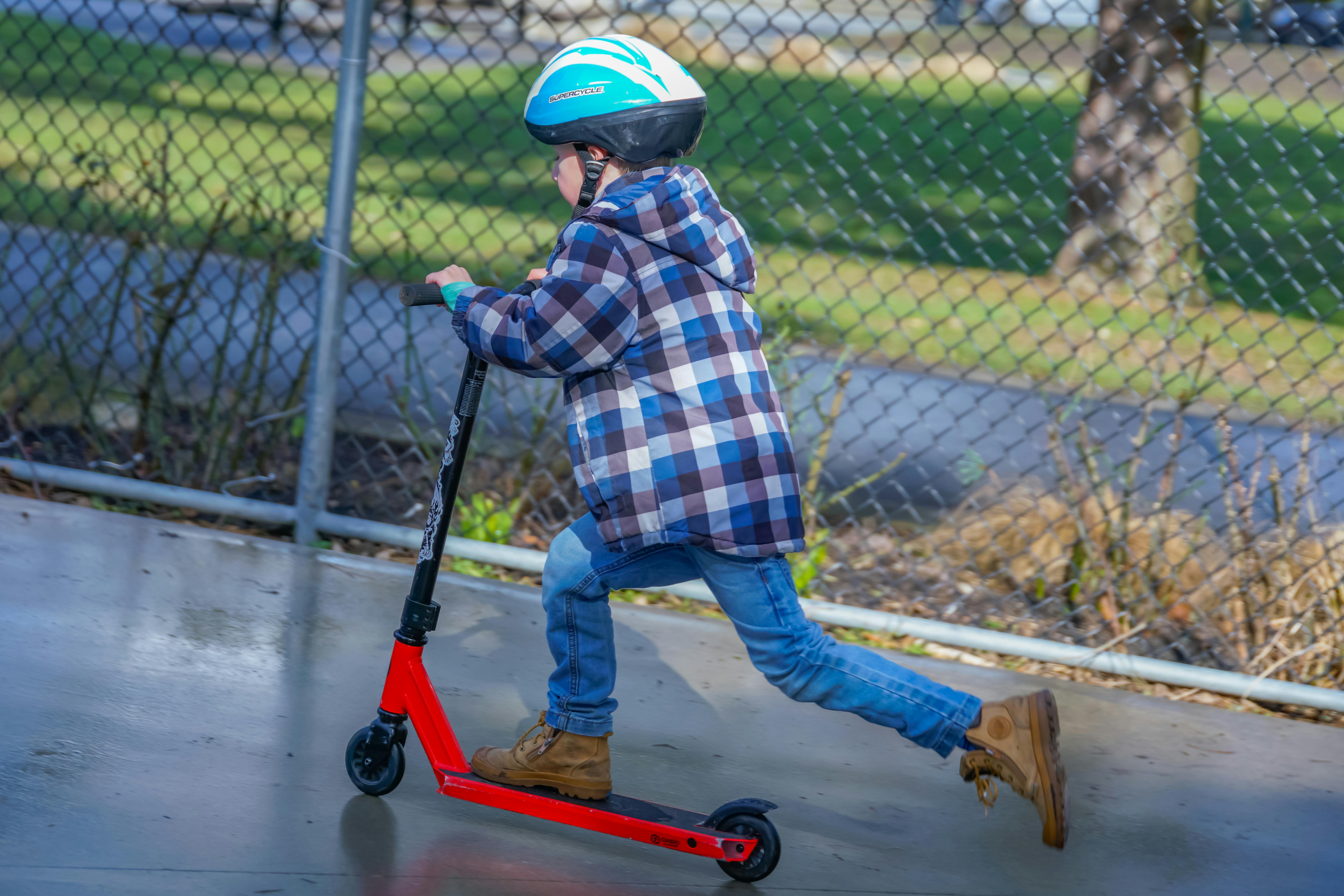 Child on a scooter in skate park