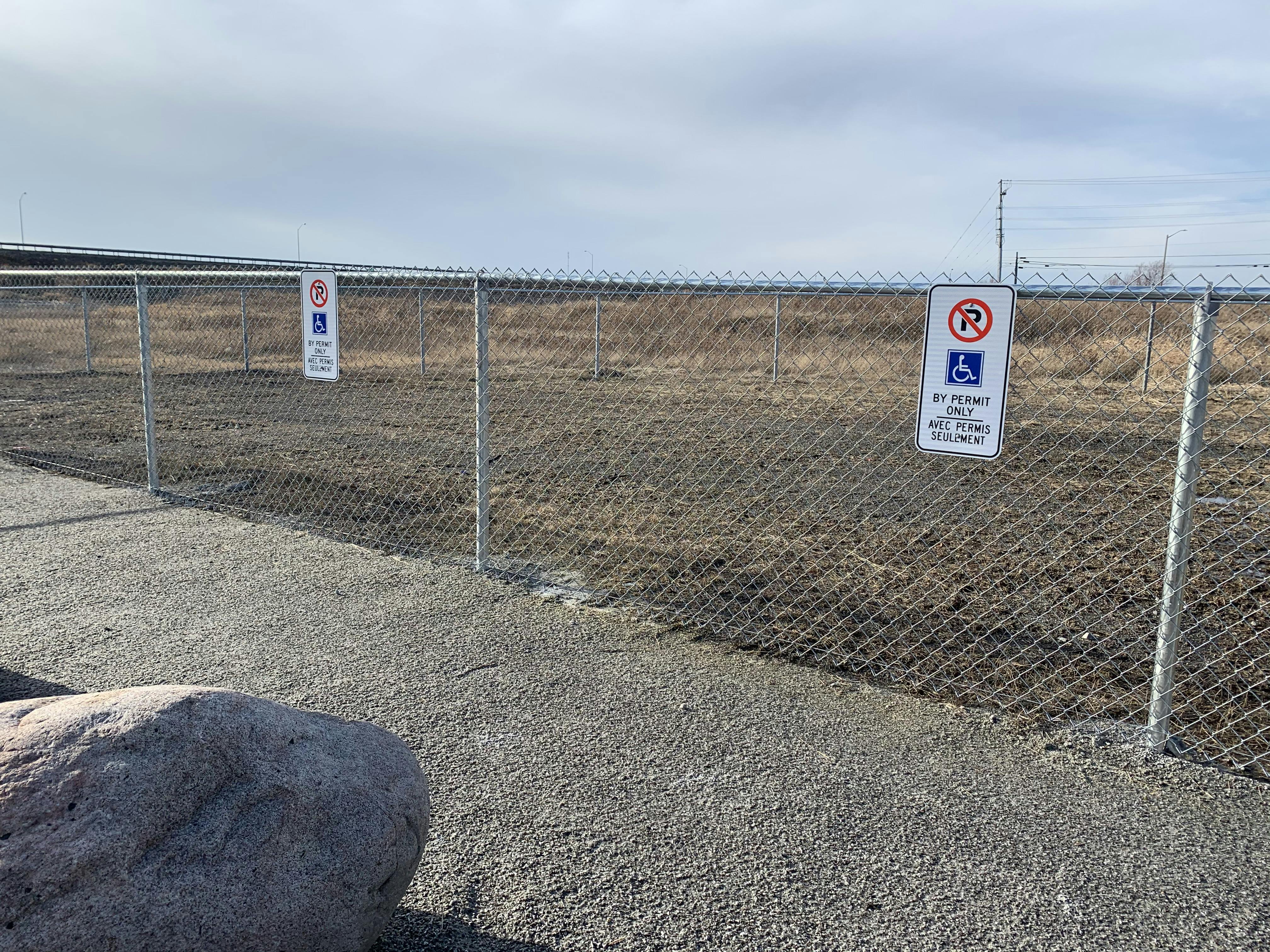 Accessible parking spaces adjacent to small dog enclosure