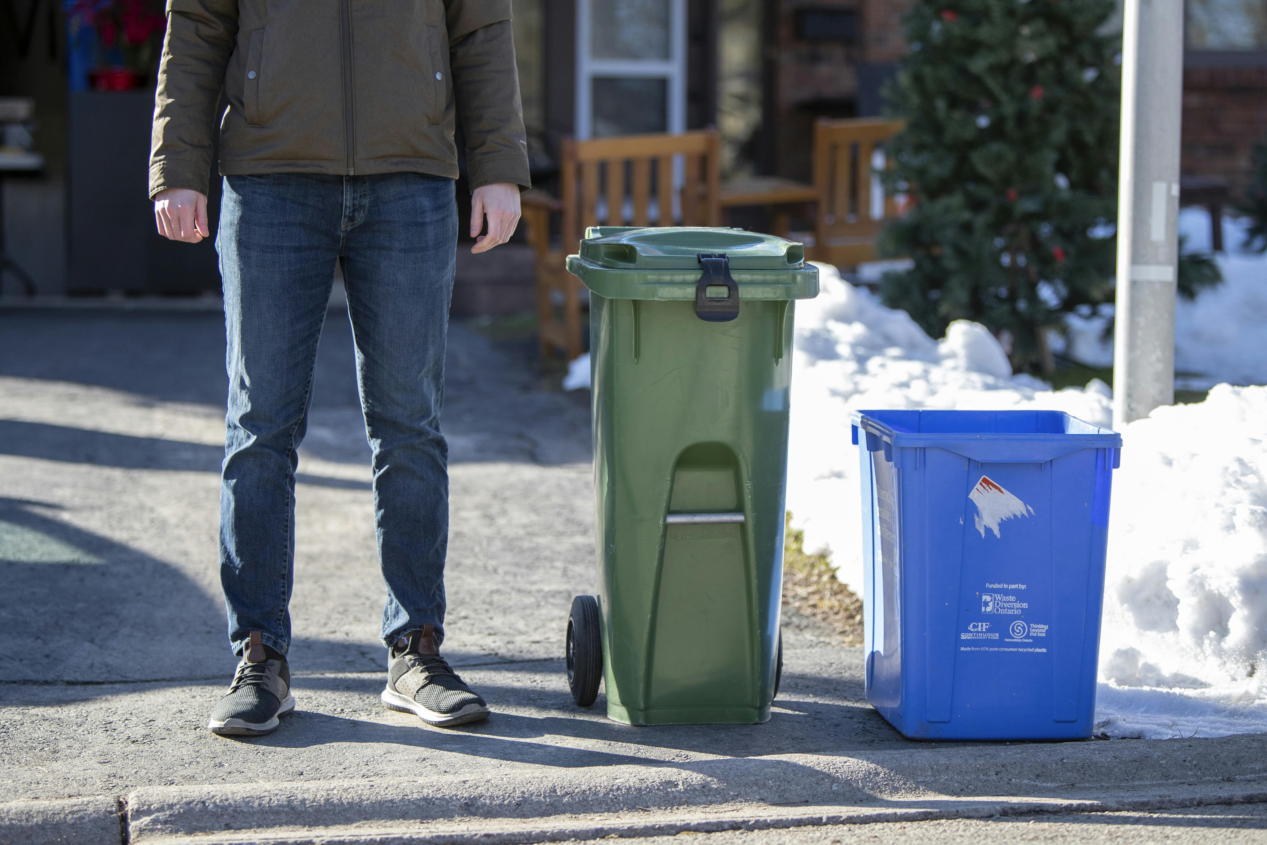 A medium size Green Bin placed at the curb