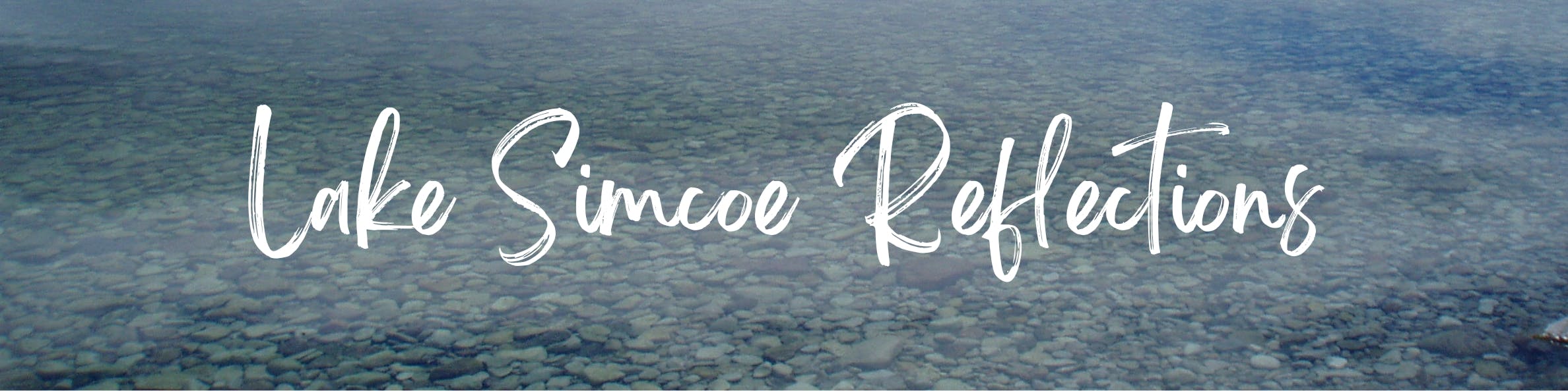 Text reading "Lake Simcoe Reflection" overlaid on an image of clear calm water on a rocky beach