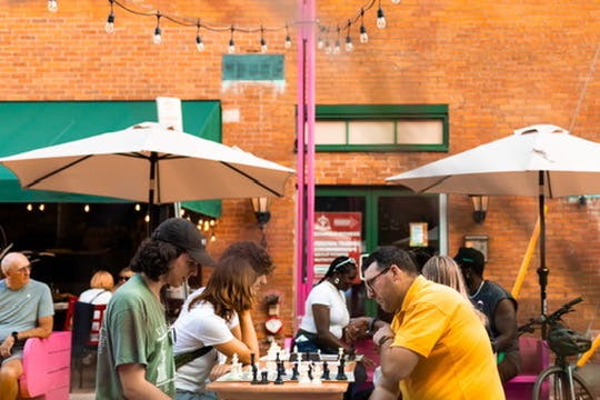 People playing chess at Chess Hive Pop-up.