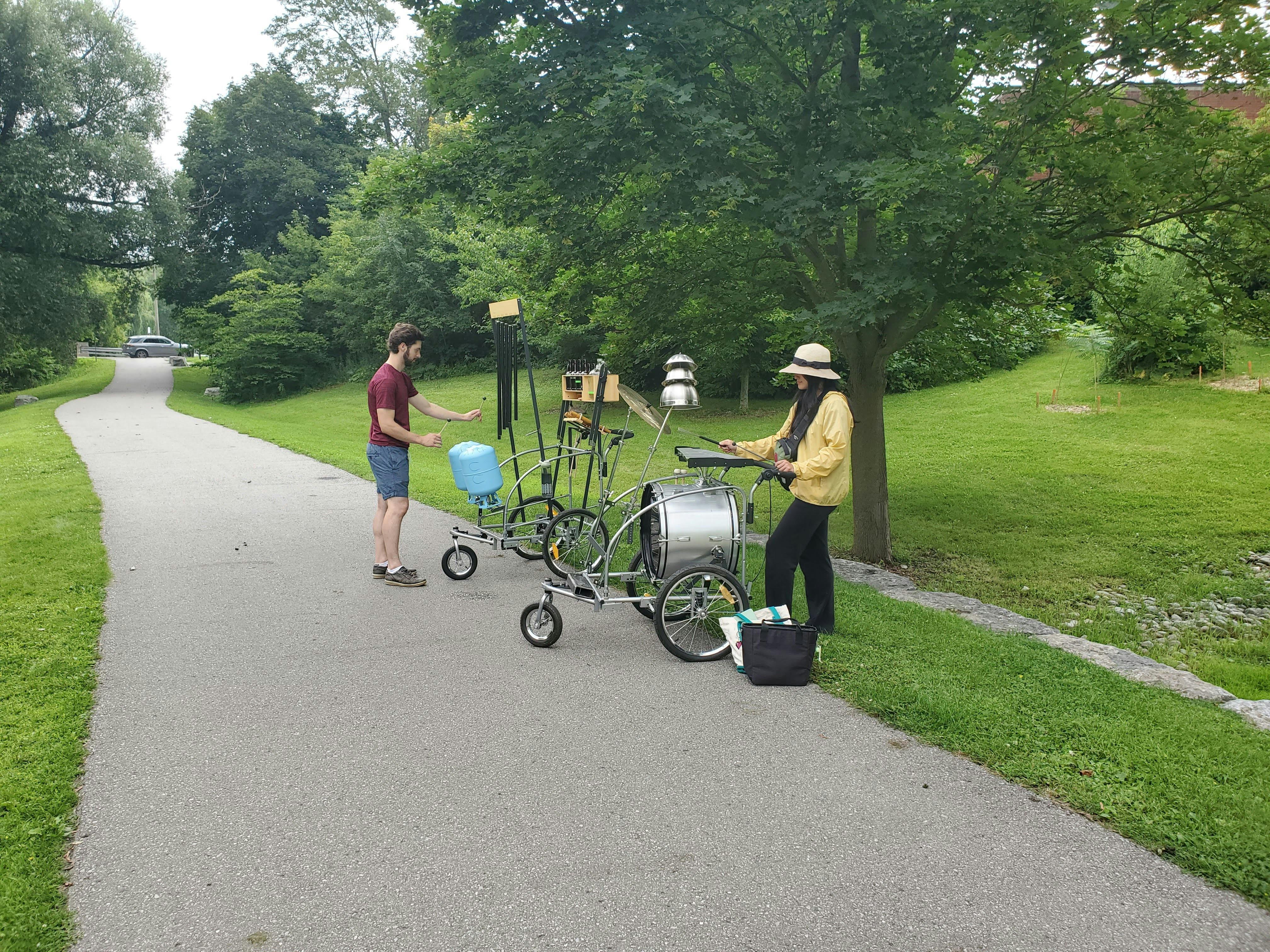 Two local musicians playing Lost and Found musical carts on the Rouge River Trail in the summer of 2023. Photo by Alessandra Pozzuoli.