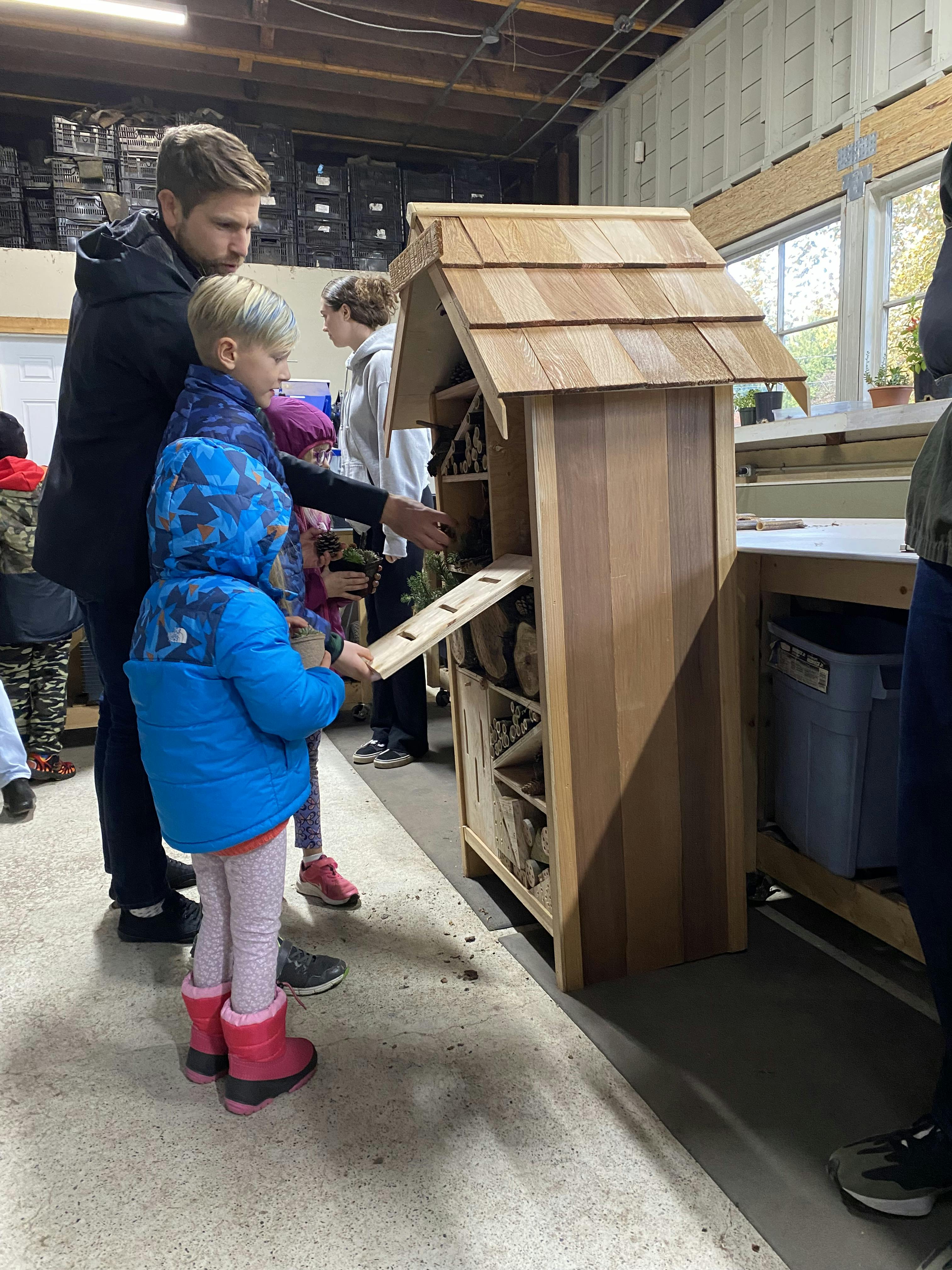 Young attendees help build an insect hotel at the drop-in engagement on November 19. 