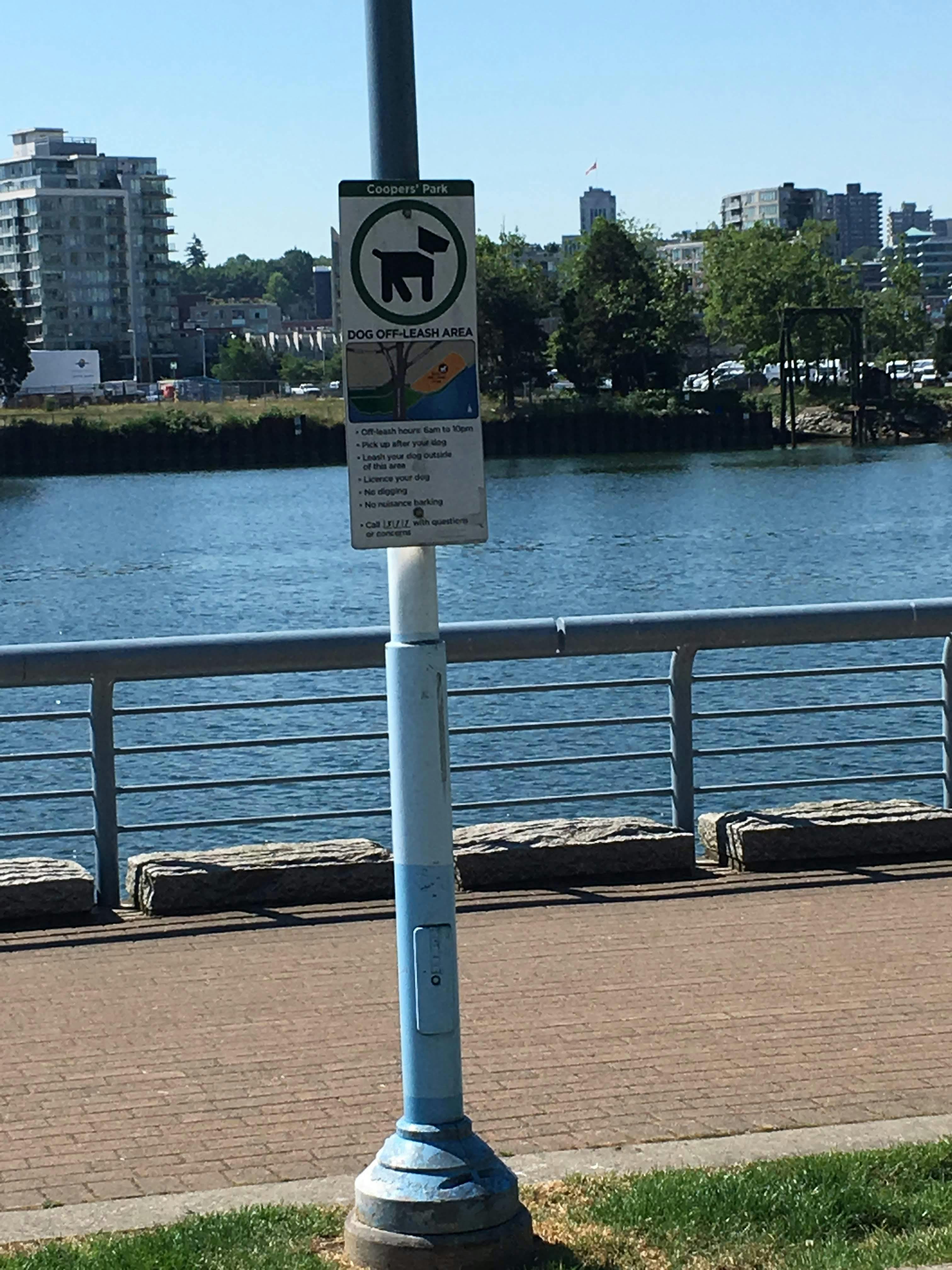 Dog off-leash sign with False Creek in background