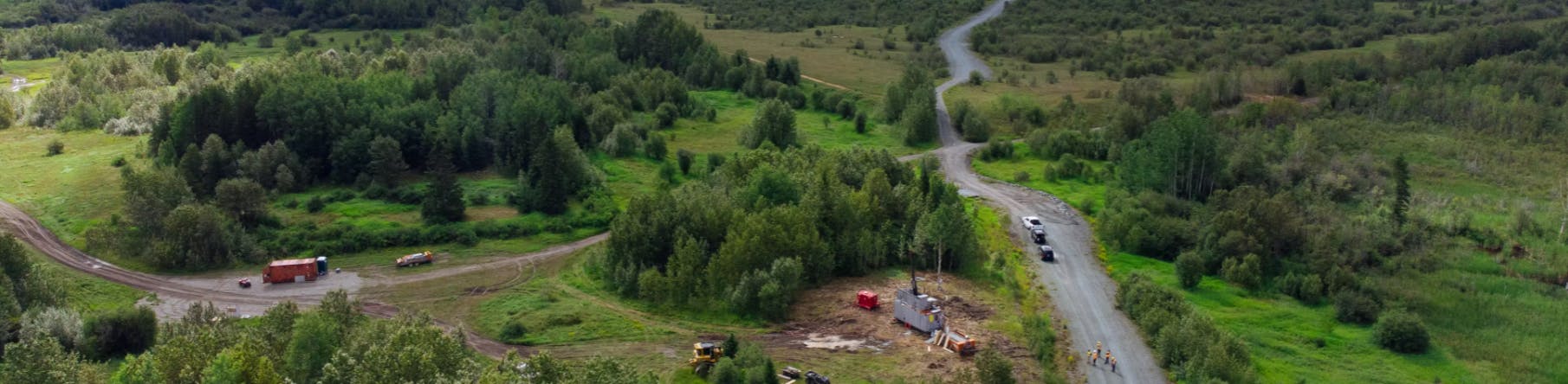 Aerial view of the site with two roads, truck and drilling