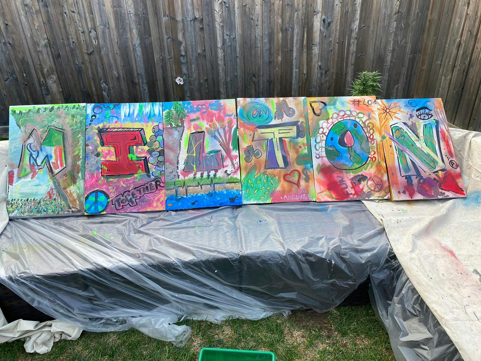 The word Milton painted on canvas. 