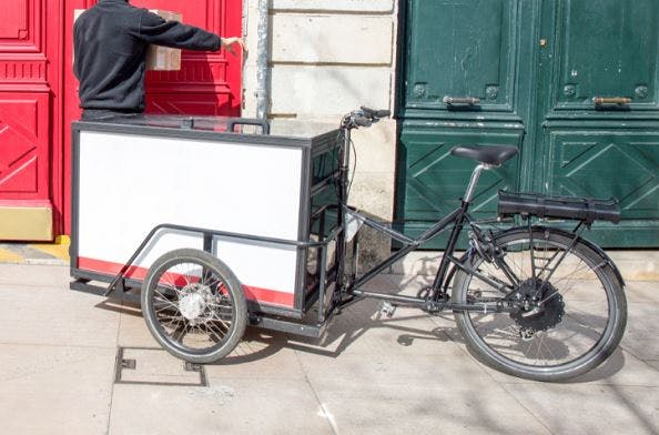A reverse tricycle design with enclosed cargo box in the front
