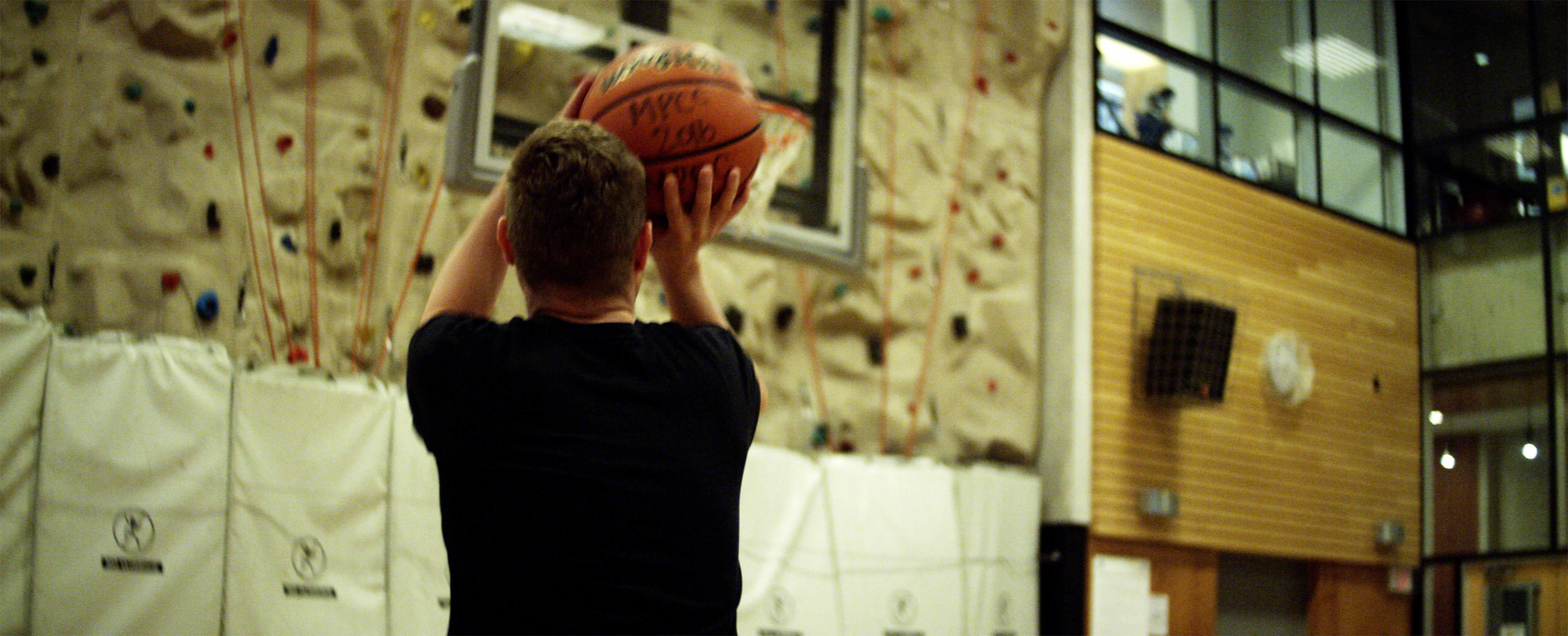 Man shooting a basketball into hoop