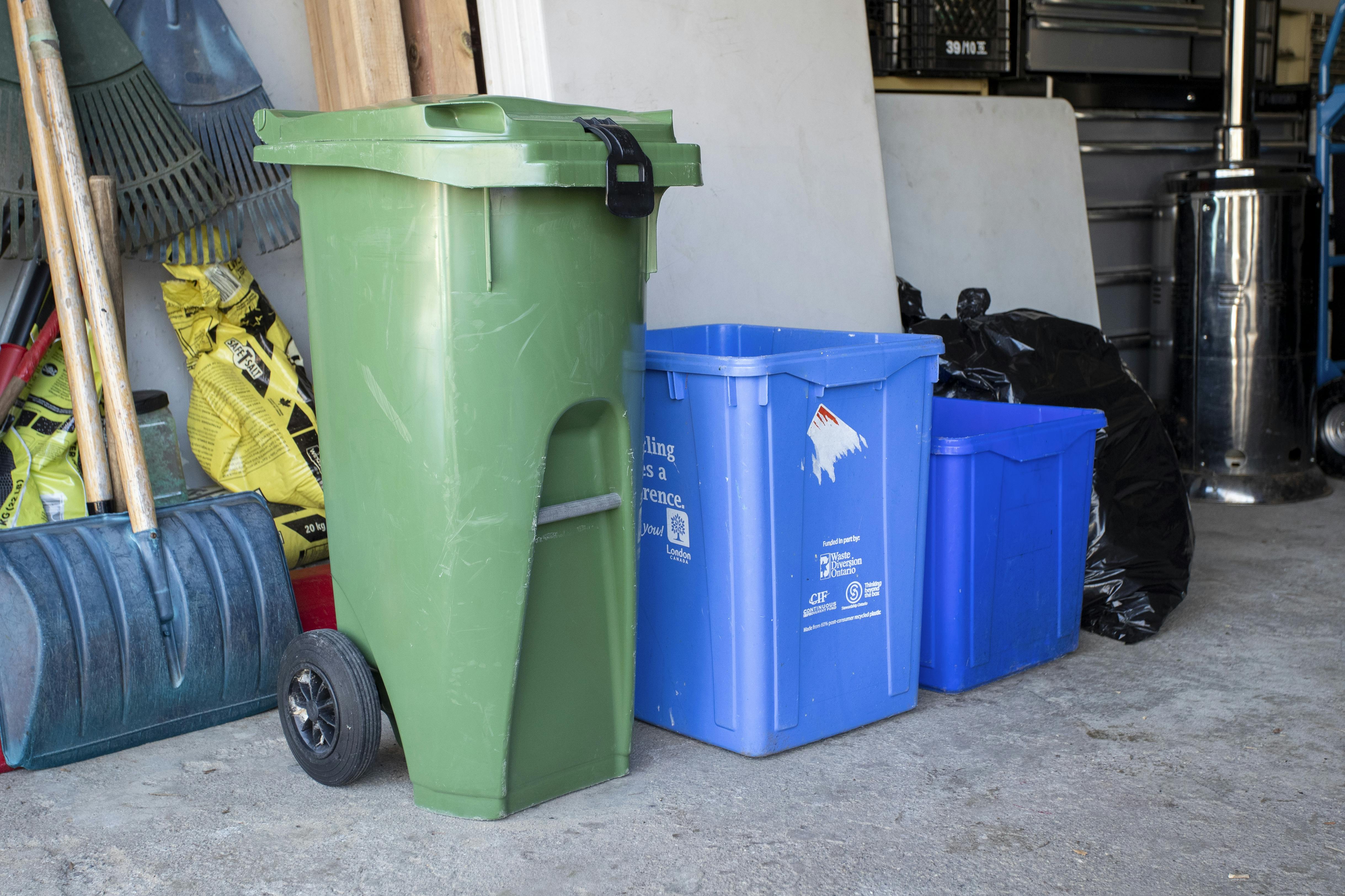 A medium size Green Bin in a garage