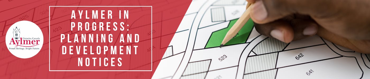 A person holding a pencil over subdivision drawing plans