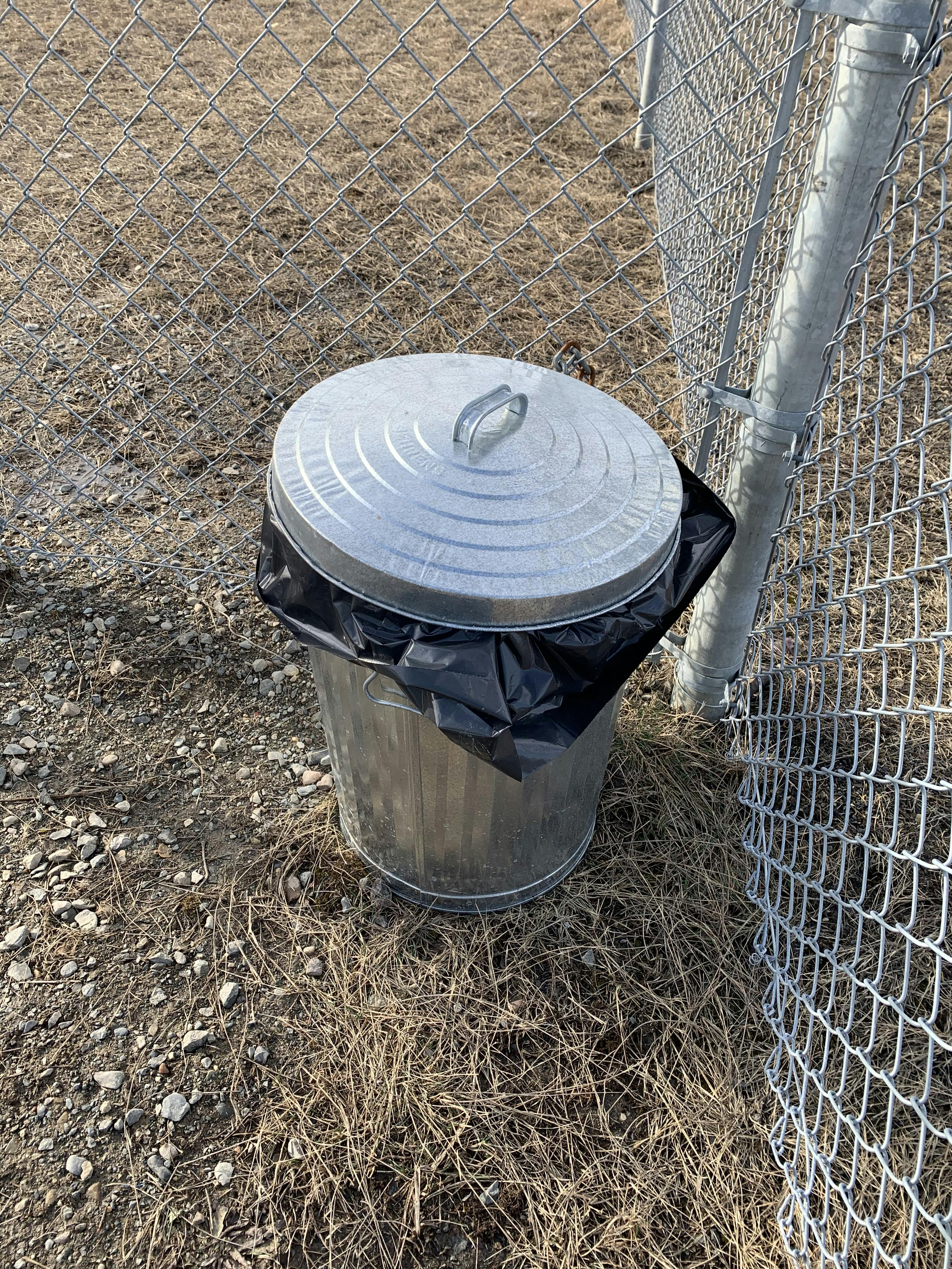 Waste can at large dog enclosure