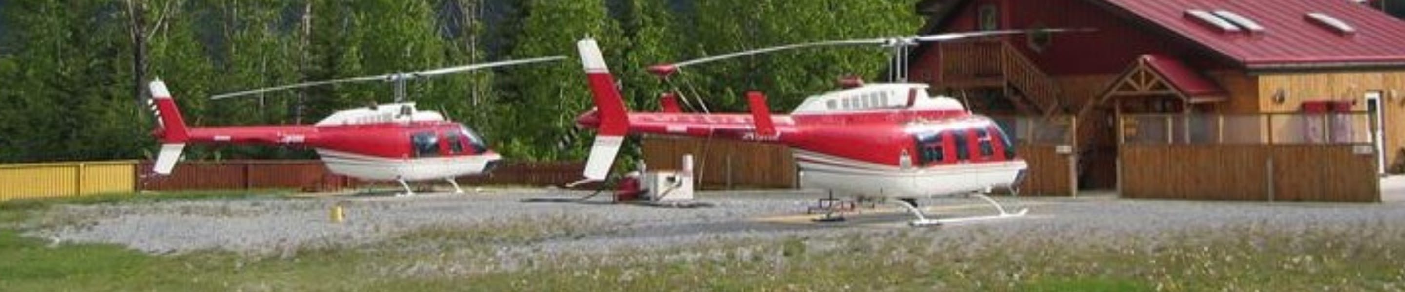 Helicopter taking off with mountains in background.