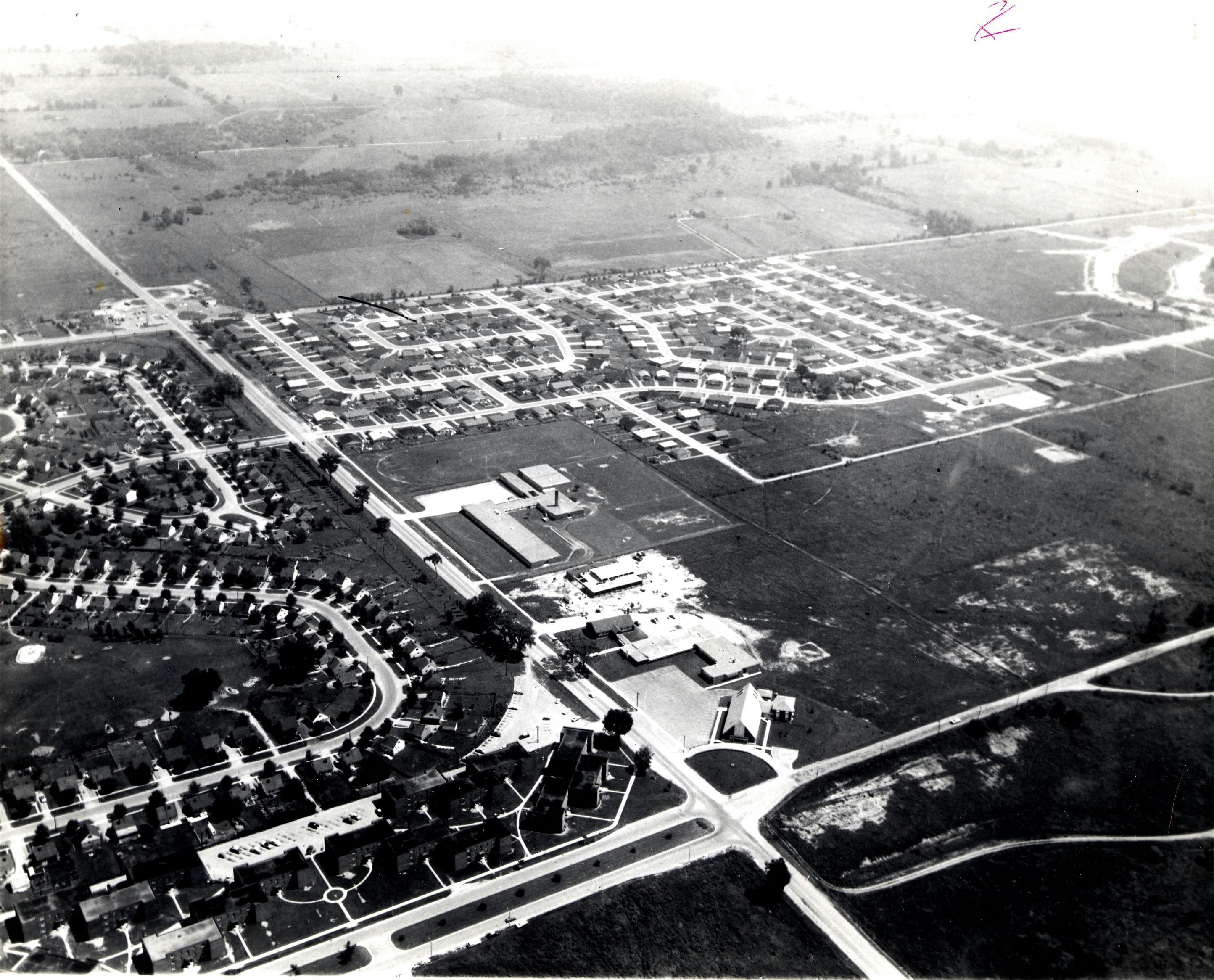c. 1960. A black and white aerial photo of Ajax. The corner of Harwood Avenue and Bayly Street can be seen in the centre foreground.. Provided by Ajax Public Library, Archives.
