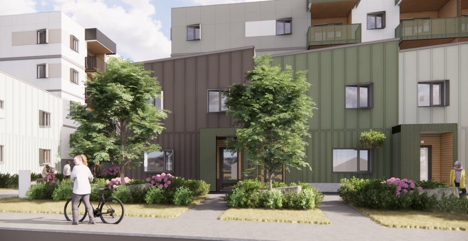 A contemporary multi-story apartment complex with green and gray panel siding and balconies, featuring the address “421 Edward St” on a sign near the entrance. The foreground includes a sidewalk, trees, and people walking or biking.