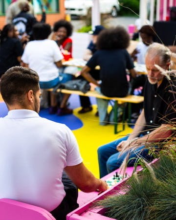 Two people playing chess at Chess Hive Pop-up.
