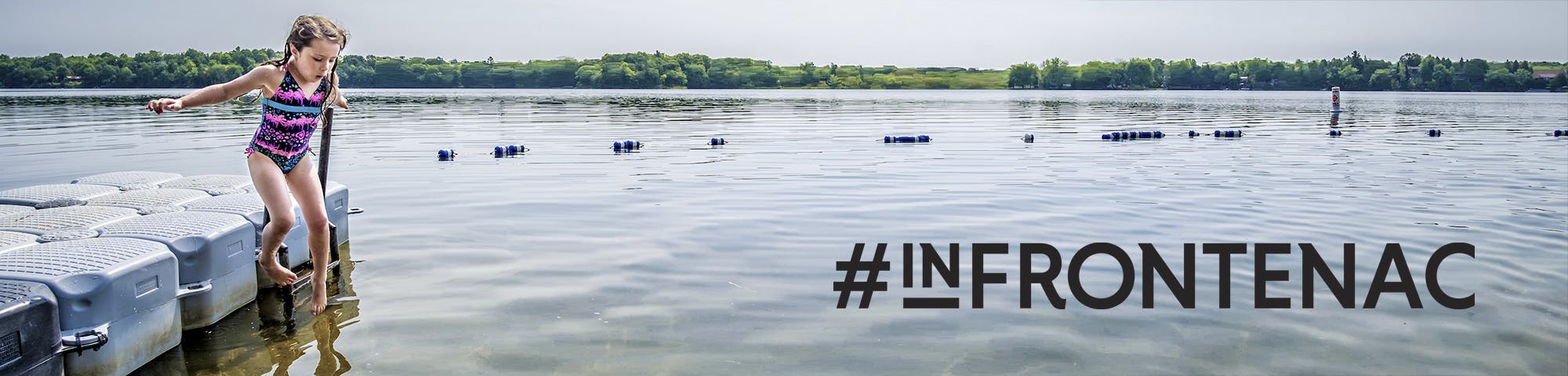 An image of a girl jumping from a dock into a lake. #InFrontenac hashtag attached. 