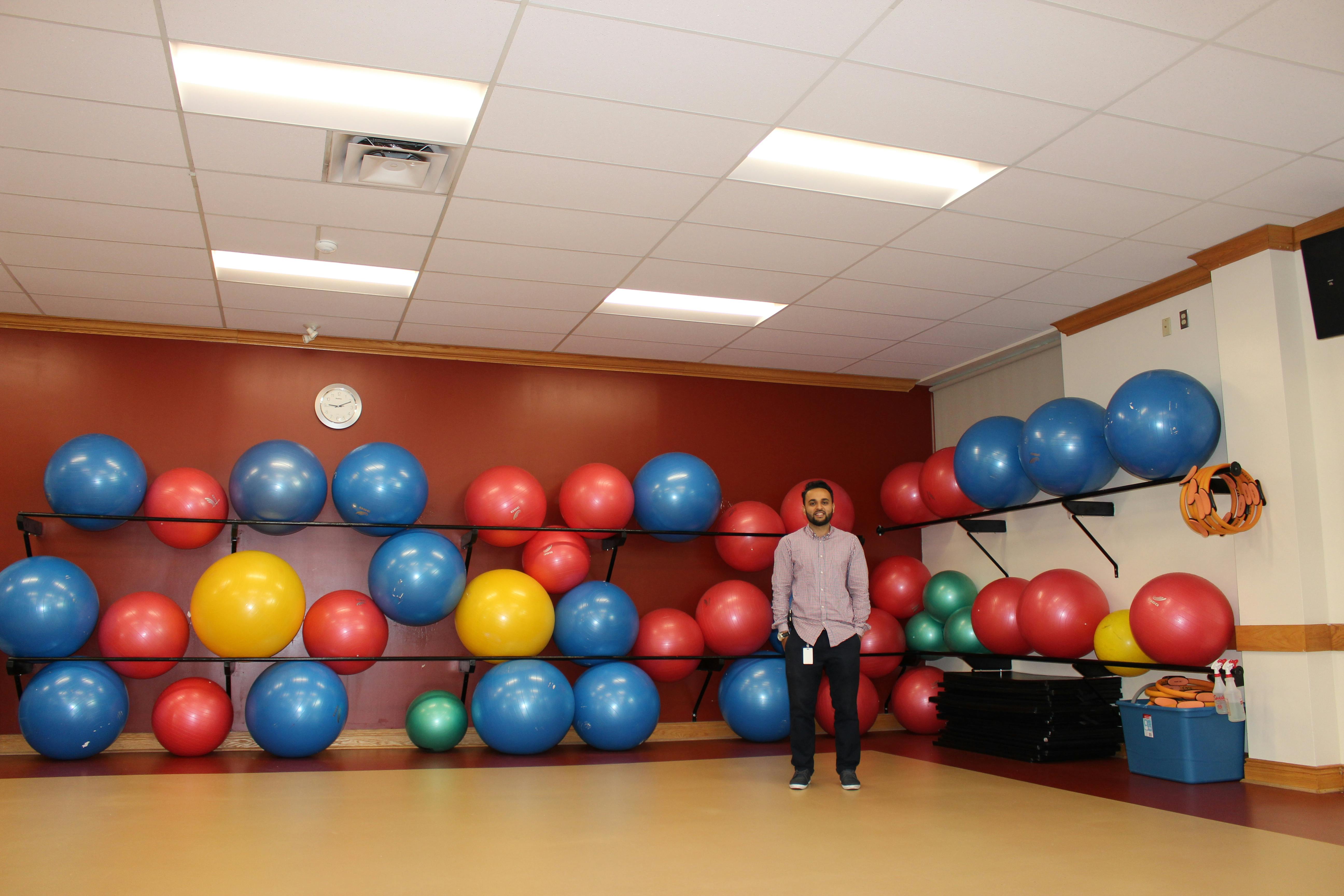 Hamid standing in the Civic Recreation Complex Aerobics Room under the new lighting system.