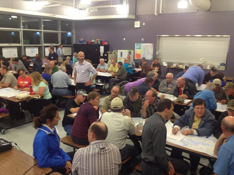 Participants break into groups to discuss questions in forum