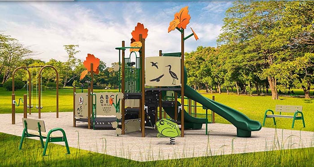 New Play Structure at St. Joseph Playground Outdoor play structure with a slide and climbing apparatus decorated with illustrations from the surrounding forest.