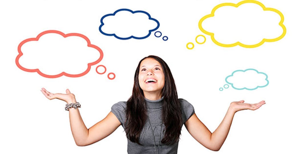Strategic thinking woman with hands in air with eight thought bubbles floating above her