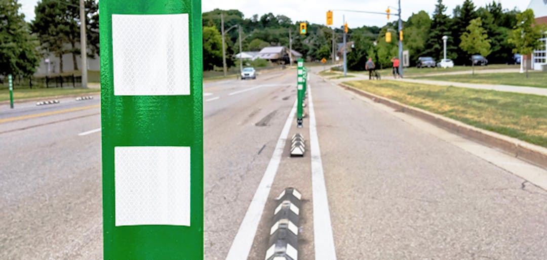 The Cycling and Trails Master Plan a separated bike lane on a busy road