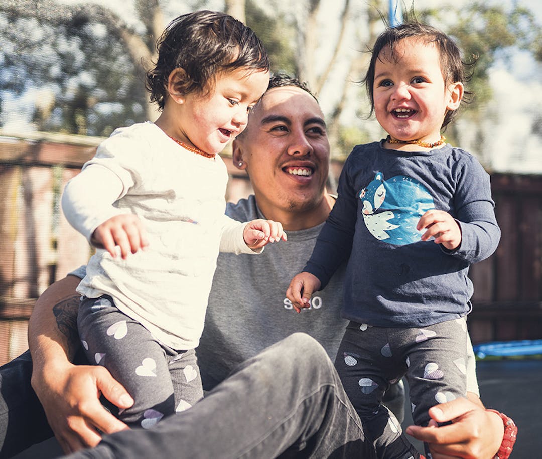 Image of father and daughters