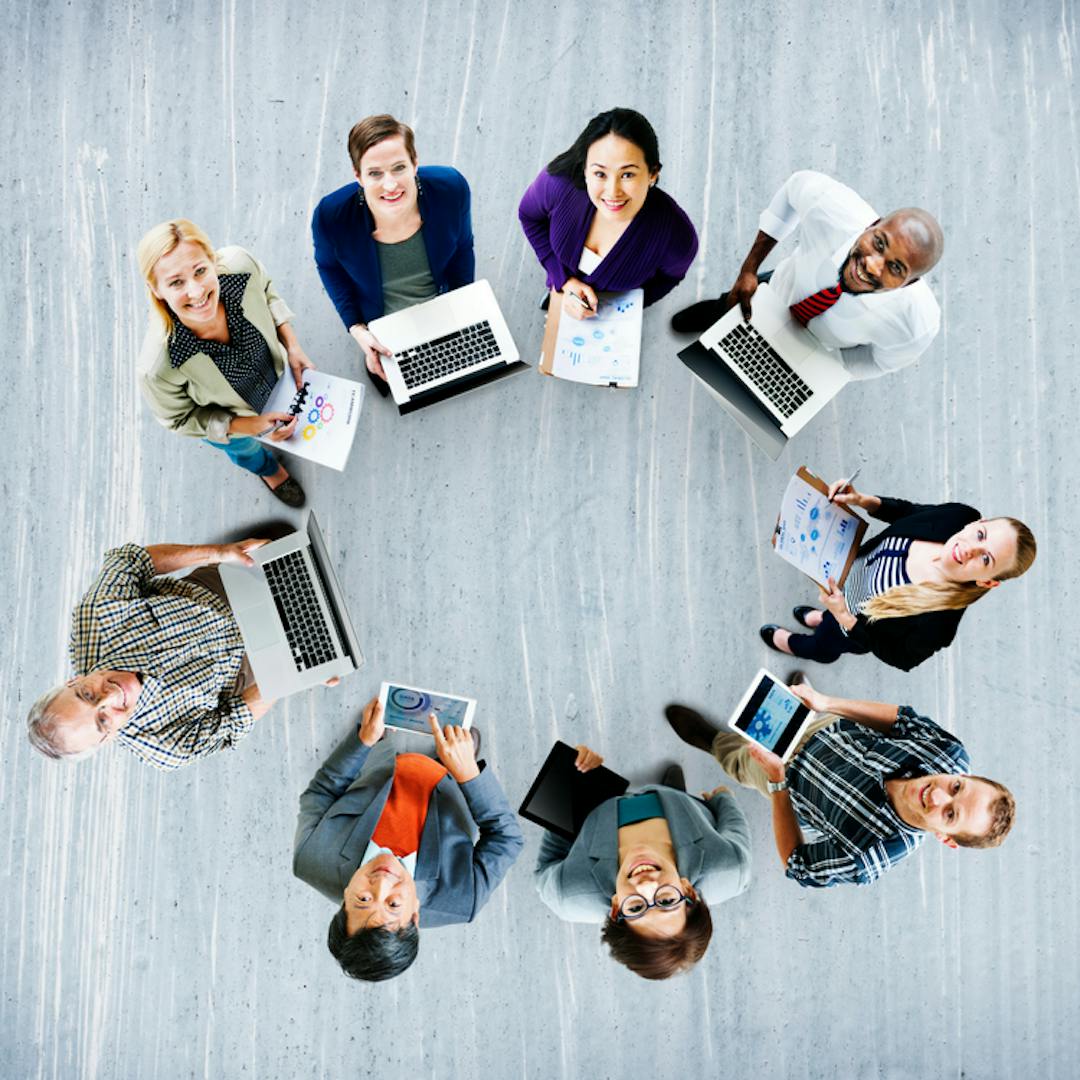 People in a circle holding smart devices