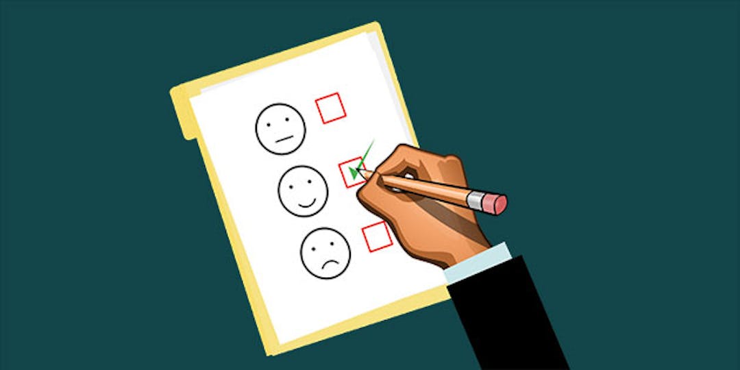 pencil in hand check marking a smiley face on a scale of good, great and sad feedback