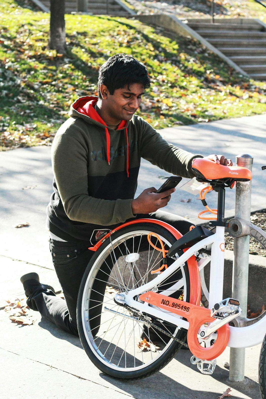 Cyclist using smartphone to unlock bike