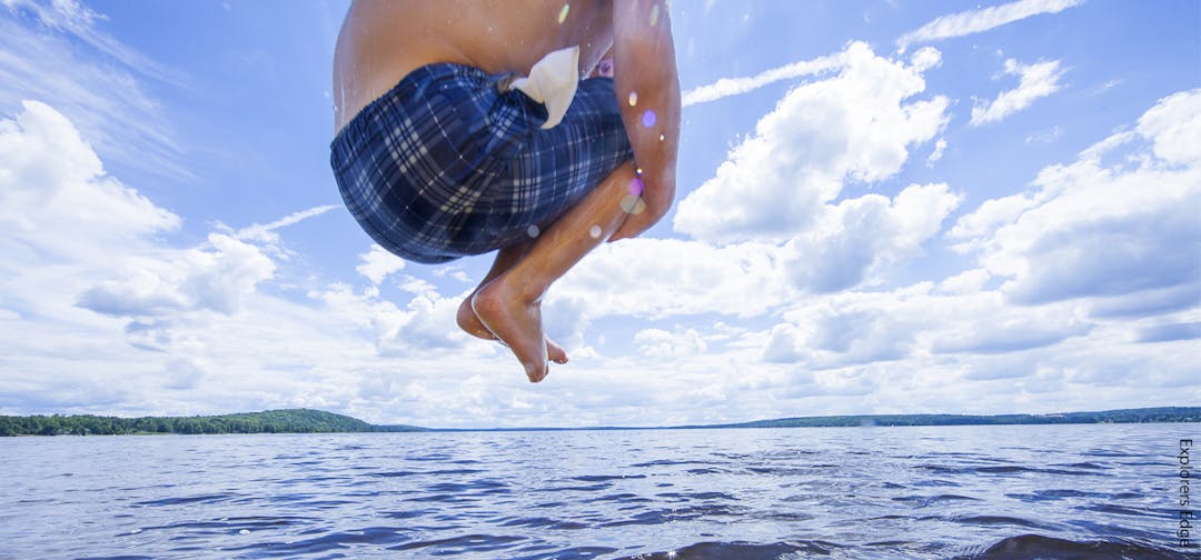 Image of Boy jumping into lake